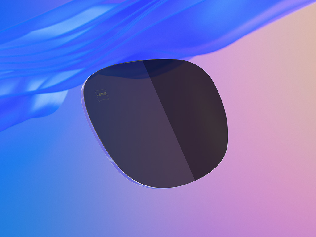 Ilustrație CGI 3D a unei lentile de ochelari de soare colorate, o jumătate având un nivel de întunecare mai ușor decât cealaltă.
